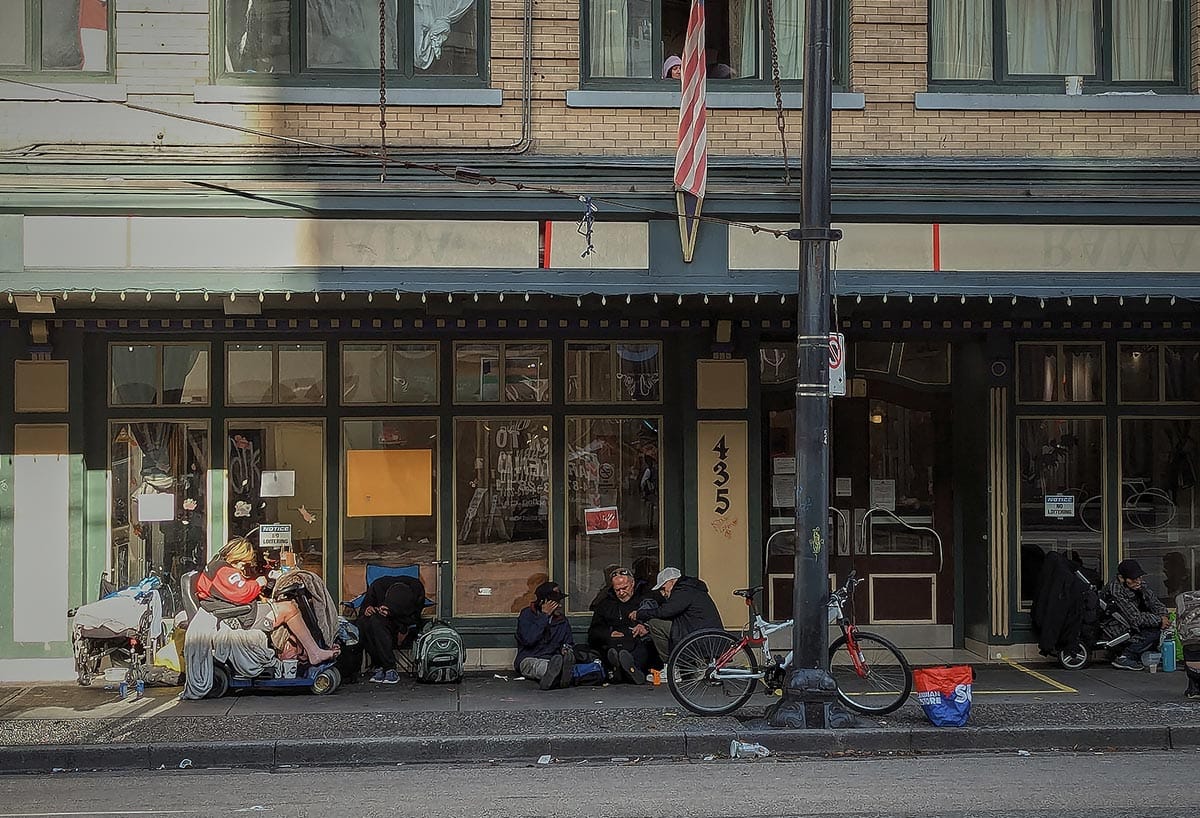 People are captured in front of Ramada Inn Hotel in Vancouver, recently converted into SRO