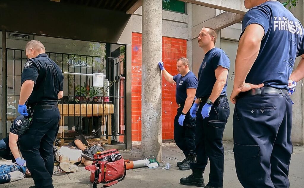 EMS and VPD Police Officers captured administering help to an overdose victim on the streets of Downtown Eastside Vancouver
