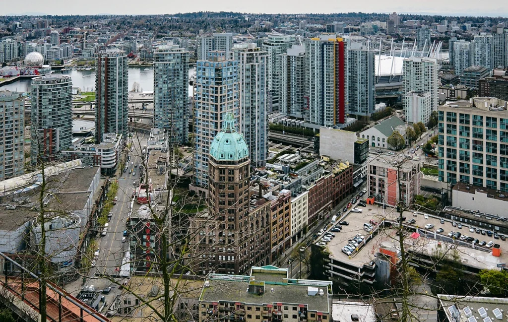 An aerial image capturing Vancouver Hastings Crossing neighbourhood with densely constructed new and historical buildings