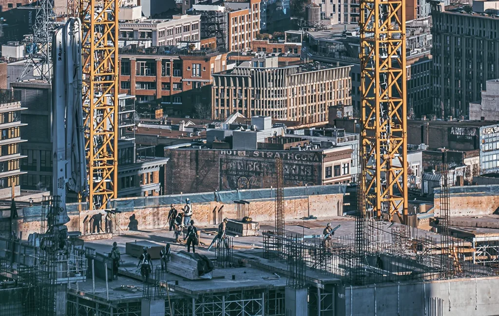 Image on active construction site in Downtown Eastside Vancouver against the backdrop of Burrard Inlet and North Shore Mountains