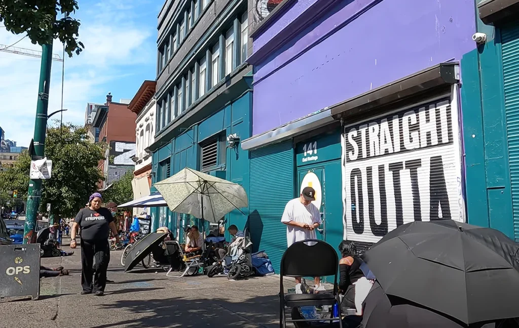 Picture of a busy Vancouver Downtown Eastside street next to safe drug use site