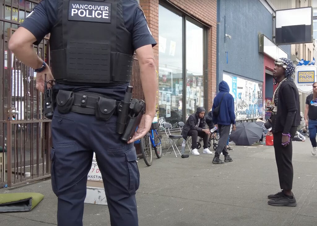 Vancouver Police Department officer captured standing on the sidewalk of East Hastings Street in Downtown Eastside Vancouver