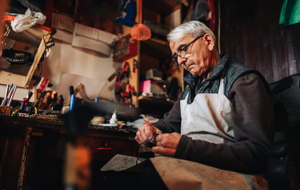 A picture of an elderly man working in the shop