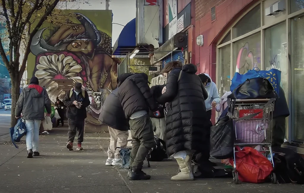 Picture of an illegal street vendors selling goods on the sidewalk of East Hastings Street in Downtown eastside Vancouver