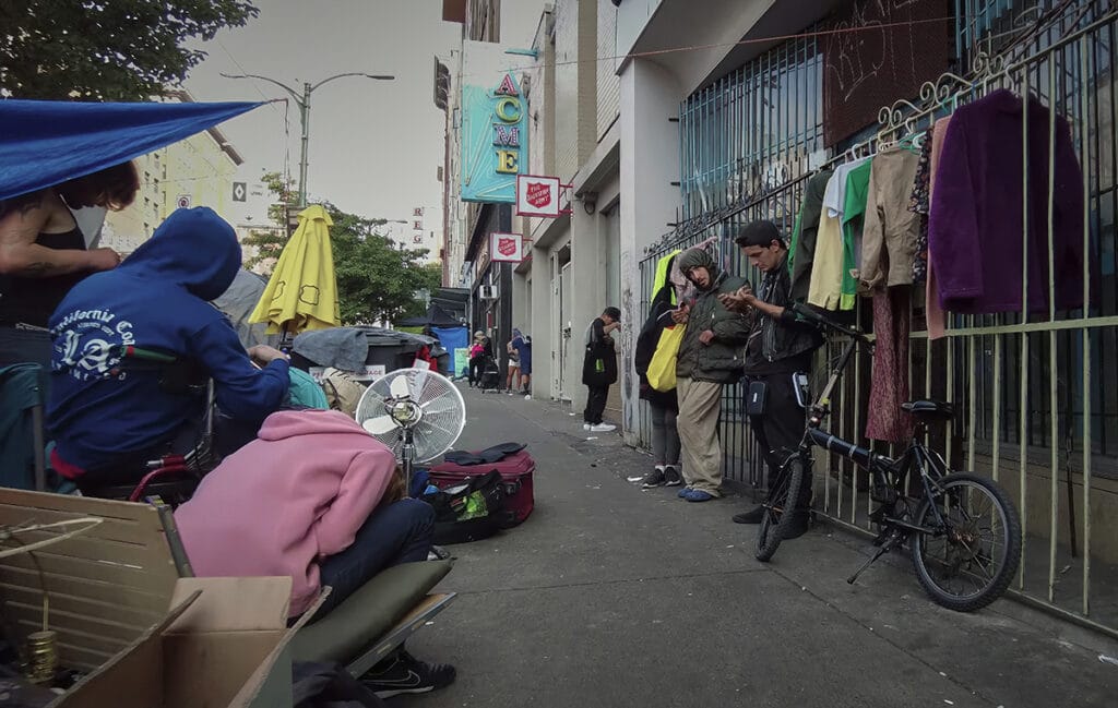 People in distress standing alongside East Hastings Street in Downtown Eastside Vancouver