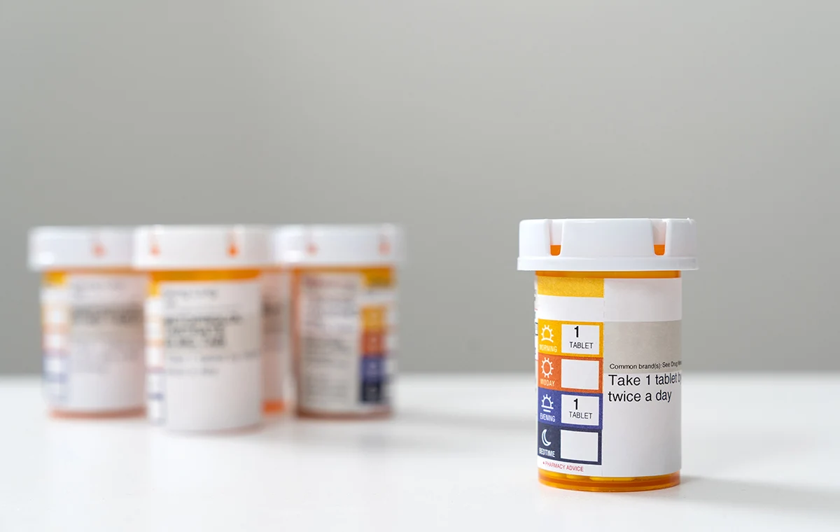 Image of several prescription bottles standing on the table