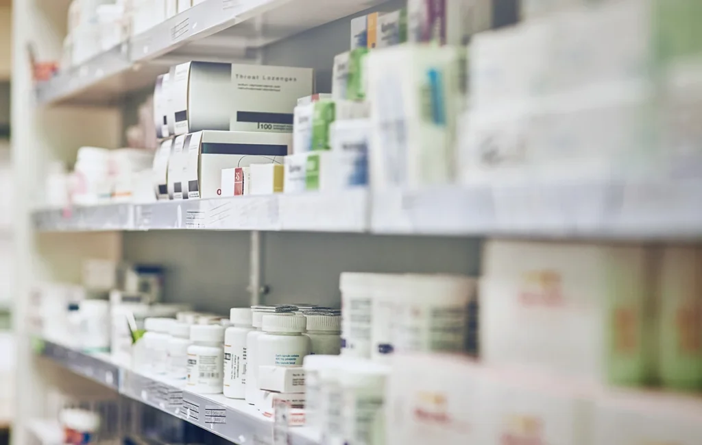 An image of a pharmacy shelf stacked with medications