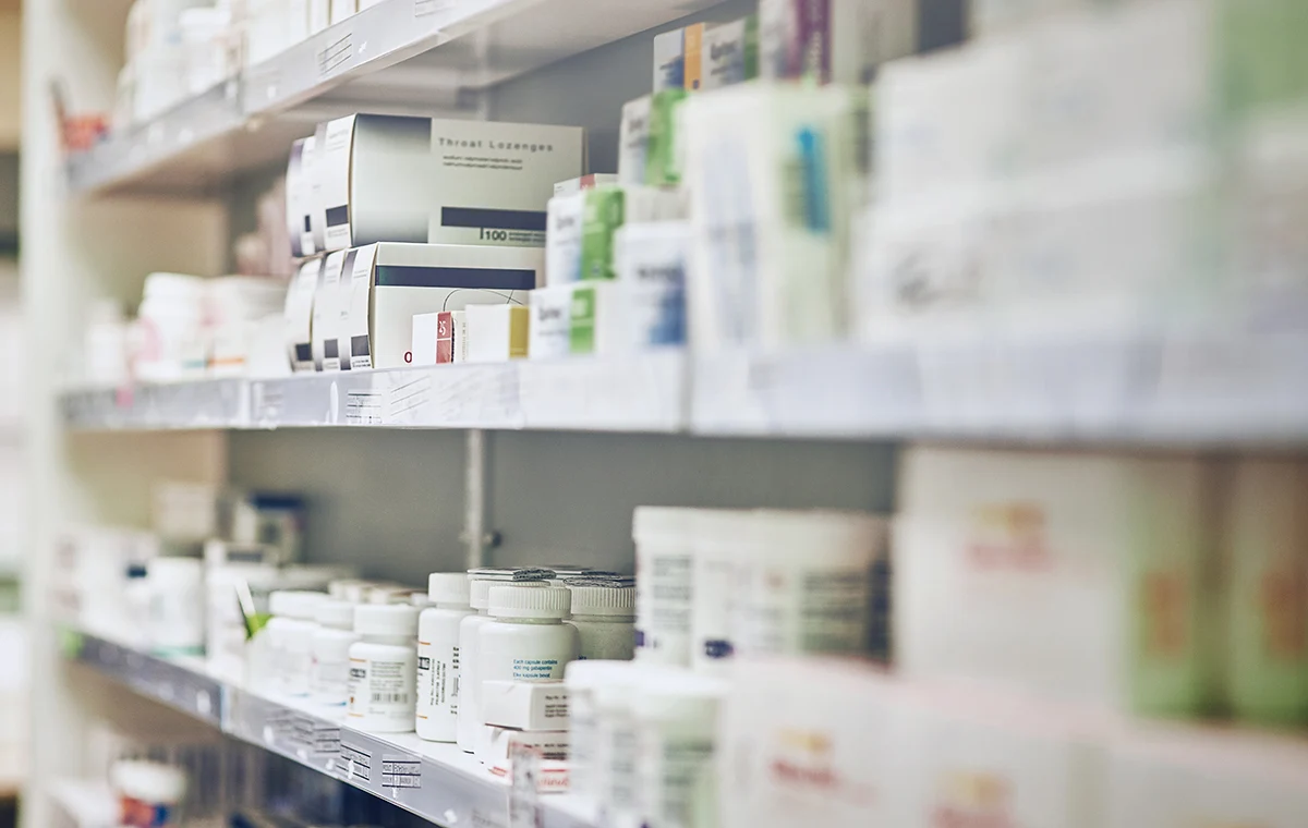 An image of a pharmacy shelf stacked with medications
